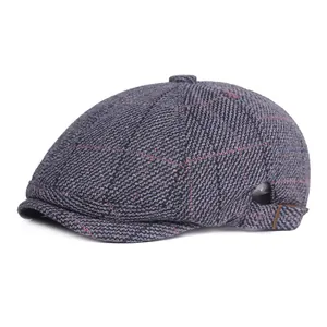 Close-up of the woven wool texture and classic plaid pattern on the beret cap