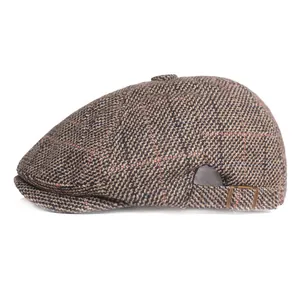 Side view of classic brown plaid wool beret with adjustable metal buckle strap
