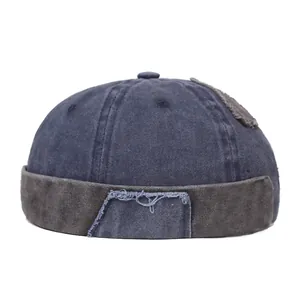 Detail of vintage washed docker hat showing navy and grey patchwork with raw edge texture