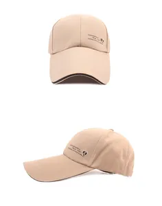 Detailed side view of tan baseball cap with embroidered lettering and metal shield logo