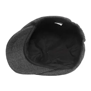 Classic grey herringbone newsboy cap featuring soft inner lining and refined woven texture