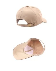 Detail view of khaki baseball cap featuring adjustable metal buckle and inner stitching