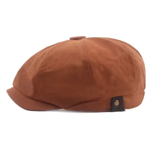 Side view of brown newsboy cap featuring a leather strap and metallic rivet detail