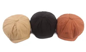 Detailed view of octagonal newsboy hats in khaki, black, and retro brick red colors