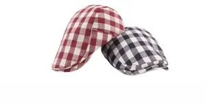 Detail of red and black checkered flat caps with breathable cotton fabric texture