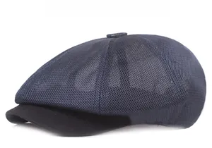 Detail view of navy mesh newsboy cap featuring breathable fabric and solid black brim