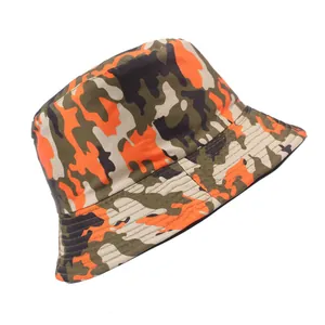 Détail macro du chapeau bob camouflage avec motifs orange et vert et bord court