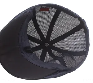 Detail of navy mesh hat interior featuring black reinforced tape and metal button
