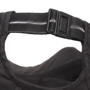 Detail of adjustable elastic back strap with reflective white line on black mesh sport cap