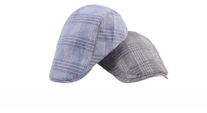 Close-up of classic plaid pattern texture on cotton-linen blend ivy caps in grey