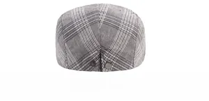 Close-up of gray striped fabric texture and precision stitching on the beret cap