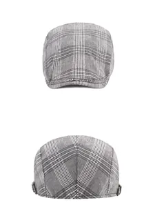 Close-up of grey plaid flat cap fabric texture and stitching details on white background
