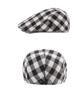 Detail view of plaid newsboy cap featuring side profile and metal snap adjustment buttons