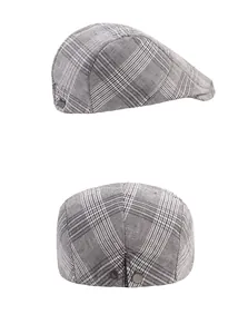 Detail view of grey plaid ivy cap showing metal side buckle and textured fabric