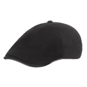 Détail d'un béret en coton noir montrant les doubles coutures et le profil lisse de la casquette