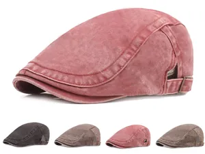 Detail of washed denim flat cap showing vintage texture and adjustable metal side buckles