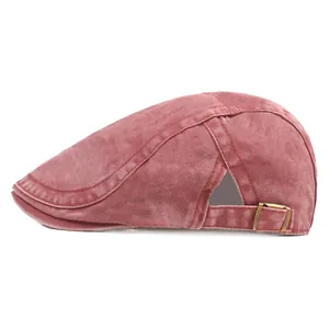 Side view of washed red denim flat cap with vintage texture and adjustable metal side buckle