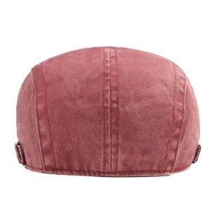 Rear view of washed cotton flat cap in brick red showing side metal adjustment buckles