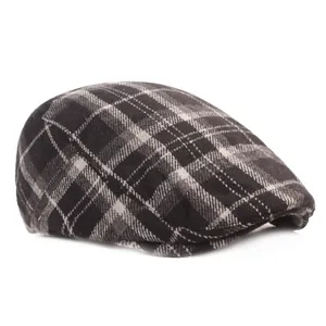 Close-up of vintage grey plaid wool flat cap showing thick texture and classic pattern