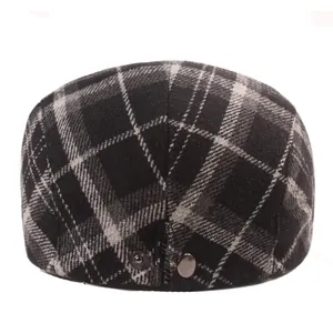 Close-up of winter wool plaid ivy cap featuring dark metal buttons and thick fabric texture
