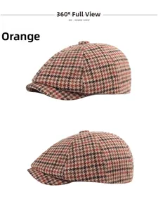 Detail view of the orange plaid vintage beret hat featuring thick tweed wool fabric texture