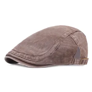 Close-up of washed cotton flat cap with adjustable metal buckle and vintage brown texture