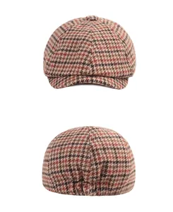Detail view of newsboy cap featuring classic houndstooth patterns and elastic back