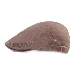 Detail of vintage brown canvas flat cap with adjustable bronze metal buckle side strap