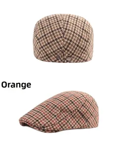 Detail of vintage striped beret featuring houndstooth pattern and metal side adjustment buckle
