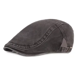 Detail of dark grey washed denim newsboy cap with metal buckle and reinforced stitching