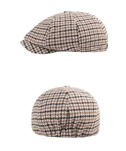 Detail of vintage houndstooth beret showing thick tweed texture and elastic back closure