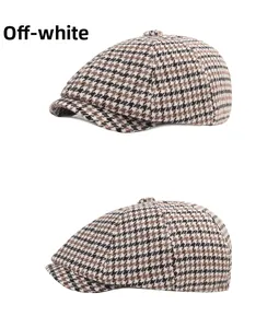 Detail view of the vintage beige houndstooth newsboy cap with classic flat top design