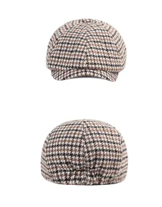 Detailed view of houndstooth newsboy cap featuring classic brown wool texture and elastic back