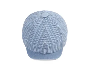 Close-up of light blue denim striped flat cap showing fabric texture and top button