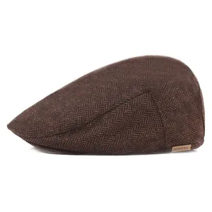 Detailed view of the dark brown herringbone wool fabric and the HATPRO metal logo plaque