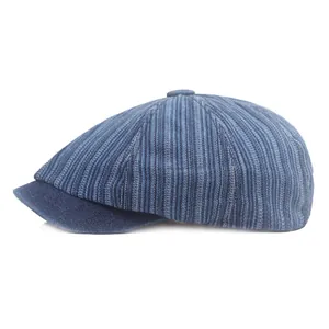 Close-up detail of the vintage denim striped newsboy cap showing texture and stitching