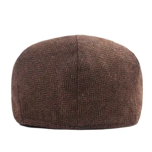 Detailed back view of brown herringbone wool blend flat cap with precise seam texture