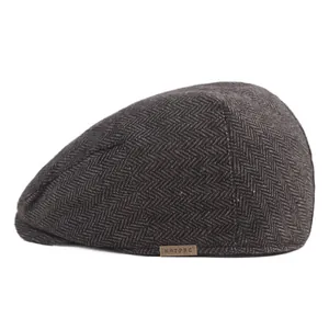 Classic dark grey herringbone flat cap with a vintage woolen texture and metal logo