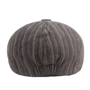 Close-up of pinstripe newsboy cap fabric with detailed multi-panel stitching and back elastic