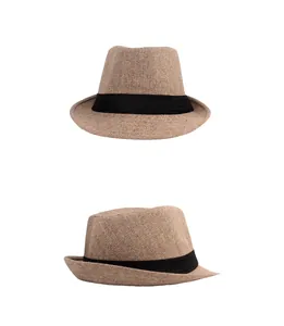 Detailed view of two brown fedora hats with black bands and textured fabric on white background