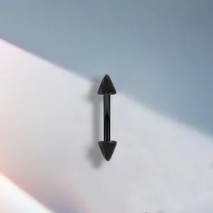 Close-up of black stainless steel barbell piercing with dual pointed cone ends