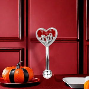 Detail of a silver curved eyebrow ring with a red flame heart motif for Halloween style