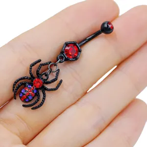 Detail of gothic spider belly ring with black metal coating and red crystals