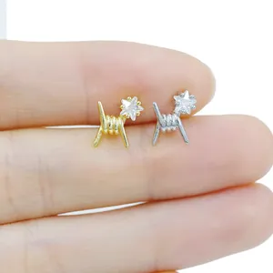 Detailed shot of star-shaped zircon labret studs with creative spiral wire design