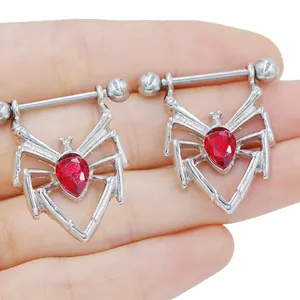 Close-up of stainless steel spider nipple rings with pear-cut red crystal stones