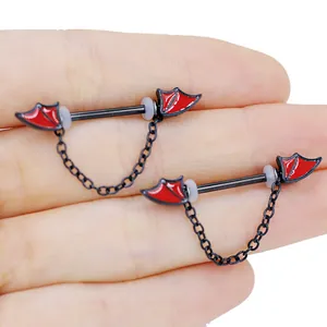Detail of gothic stainless steel nipple ring with red bat wings and black chain link