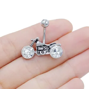 Macro shot of silver motorcycle belly ring featuring two sparkling zircon wheels