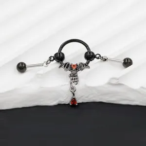 Detailed view of Gothic bat nipple ring with red heart gem and droplet pendant