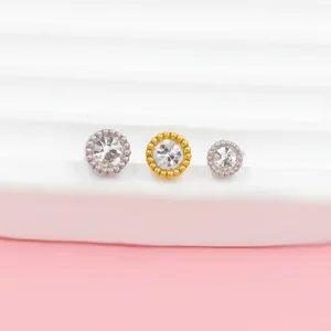 Macro shot of stainless steel stud piercings with cubic zirconia and beaded edges