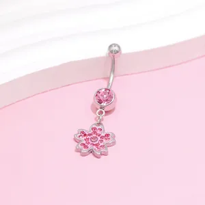 Detailed view of pink cherry blossom navel ring with sparkling crystal inlay decoration